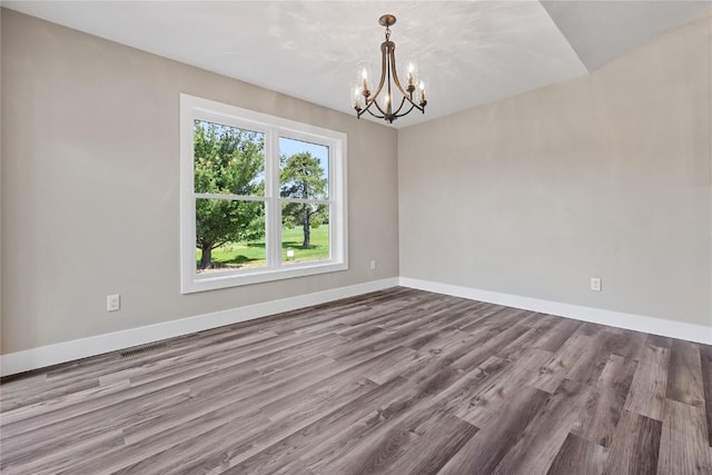 468 Chamber Dr, Anamosa, IA 52205 - unfurnished room with a chandelier and wood finished floors