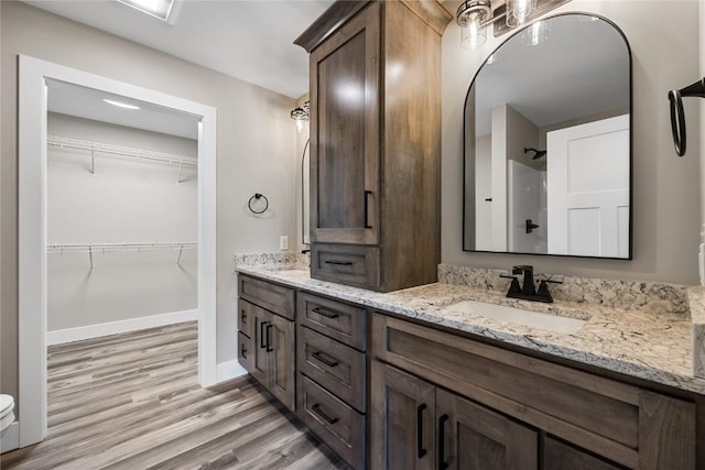 468 Chamber Dr, Anamosa, IA 52205 - full bath with double vanity, wood finished floors, a shower, and a walk in closet