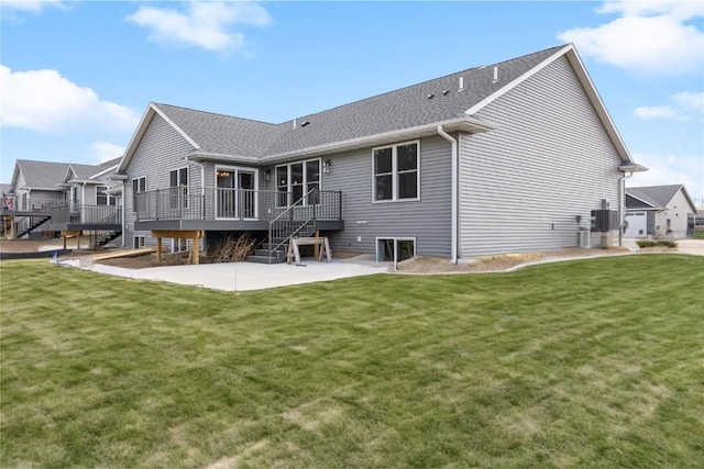 468 Chamber Dr, Anamosa, IA 52205 - rear view of house featuring a patio area, a wooden deck, a yard, and roof with shingles