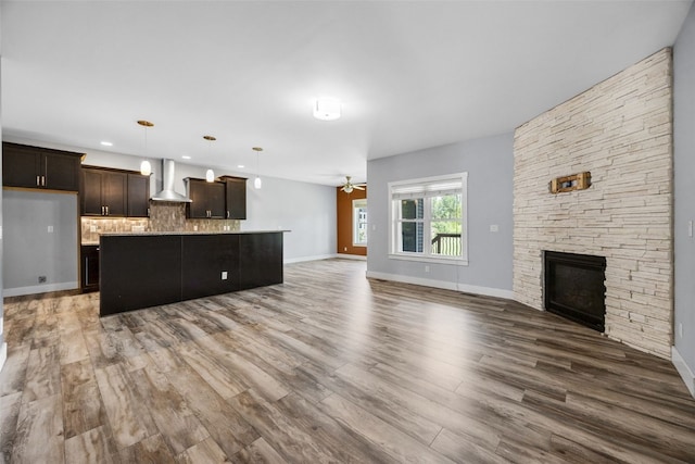 4310 Carpenter Rd NE, Cedar Rapids, IA 52411 - unfurnished living room with a ceiling fan, a fireplace, and wood finished floors