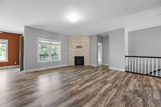 4310 Carpenter Rd NE, Cedar Rapids, IA 52411 - unfurnished living room with wood finished floors and a fireplace
