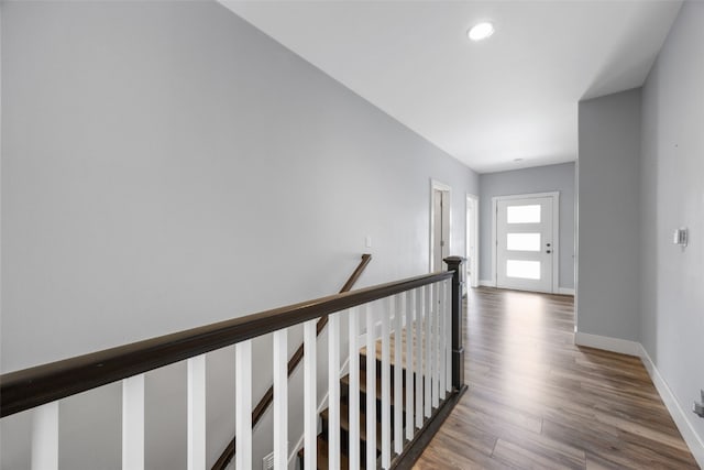4310 Carpenter Rd NE, Cedar Rapids, IA 52411 - hallway with wood finished floors, recessed lighting, and an upstairs landing