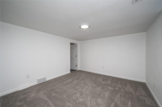 446 19th NW, Cedar Rapids, IA 52405 - unfurnished room featuring dark carpet and a textured ceiling