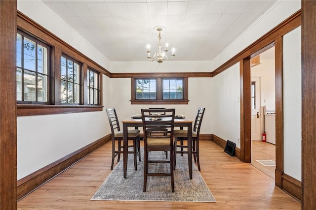 395 18th St SE, Cedar Rapids, IA 52403 - dining area with a chandelier, plenty of natural light, light wood finished floors, and ornamental molding