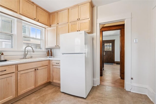 395 18th St SE, Cedar Rapids, IA 52403 - kitchen featuring freestanding refrigerator, light brown cabinets, and light countertops