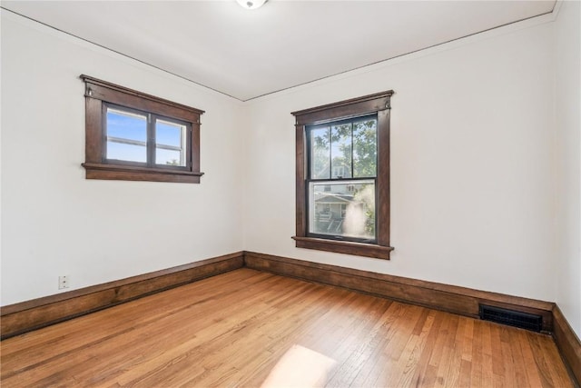 395 18th St SE, Cedar Rapids, IA 52403 - unfurnished room with plenty of natural light, hardwood / wood-style floors, and crown molding