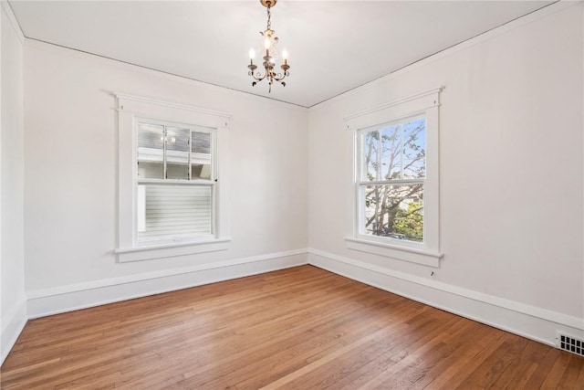 395 18th St SE, Cedar Rapids, IA 52403 - empty room featuring a chandelier and wood finished floors