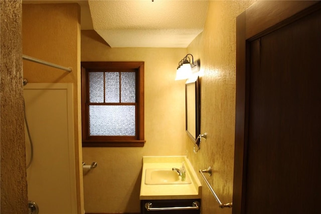 302 S Main St, Monticello, IA 52310 - full bath with vanity, a textured ceiling, and a shower
