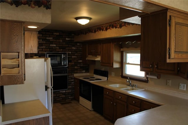 302 S Main St, Monticello, IA 52310 - kitchen featuring black appliances, under cabinet range hood, light countertops, and tile patterned floors