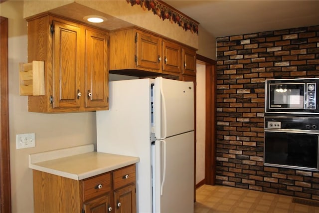 302 S Main St, Monticello, IA 52310 - kitchen featuring black appliances, brown cabinets, light countertops, and light flooring