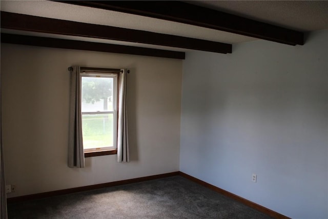 302 S Main St, Monticello, IA 52310 - unfurnished room with beam ceiling and dark carpet
