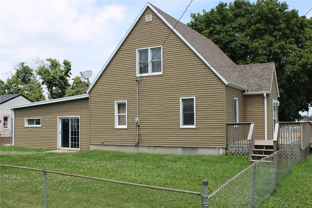 302 S Main St, Monticello, IA 52310 - back of property featuring a wooden deck, a fenced backyard, and a shingled roof