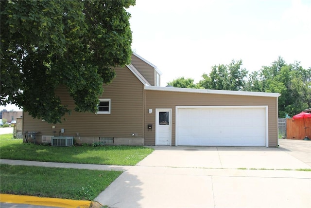 302 S Main St, Monticello, IA 52310 - view of front of property featuring a front yard, a garage, and concrete driveway