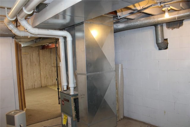 302 S Main St, Monticello, IA 52310 - unfinished basement featuring wood walls and heating unit