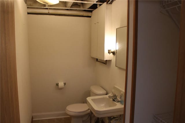 302 S Main St, Monticello, IA 52310 - half bathroom featuring a sink and toilet
