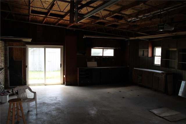 302 S Main St, Monticello, IA 52310 - garage featuring a garage door opener and wood walls