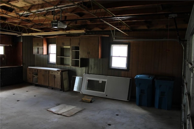 302 S Main St, Monticello, IA 52310 - garage with a garage door opener and wooden walls