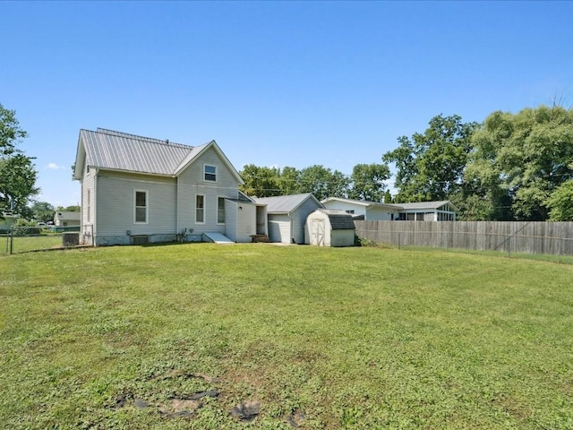 226 2nd Ave E, Lisbon, IA 52253 - back of property with a storage shed, a fenced backyard, and a metal roof