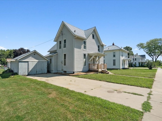 226 2nd Ave E, Lisbon, IA 52253 - view of home's exterior with an outbuilding, a yard, and a metal roof