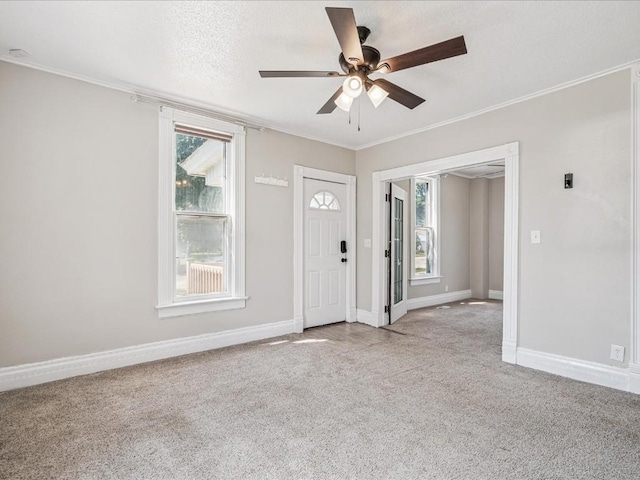 226 2nd Ave E, Lisbon, IA 52253 - foyer with carpet floors, ceiling fan, and ornamental molding