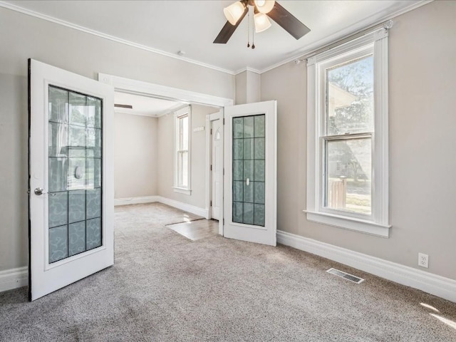 226 2nd Ave E, Lisbon, IA 52253 - spare room with carpet, ornamental molding, and a ceiling fan