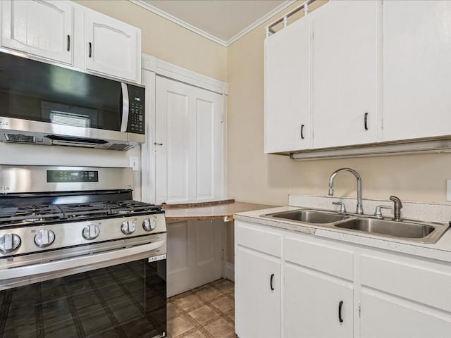 226 2nd Ave E, Lisbon, IA 52253 - kitchen with stainless steel appliances, ornamental molding, light countertops, and white cabinets