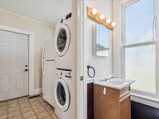 226 2nd Ave E, Lisbon, IA 52253 - washroom with estacked washer and dryer and ornamental molding