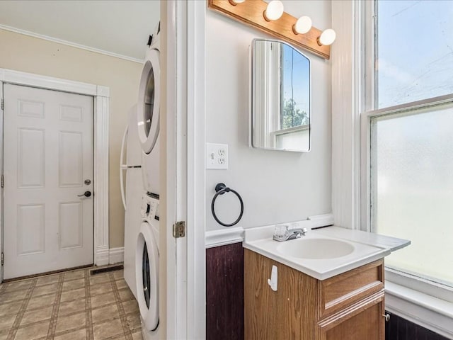 226 2nd Ave E, Lisbon, IA 52253 - laundry area with stacked washer and clothes dryer, light flooring, and ornamental molding