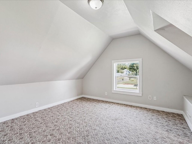 226 2nd Ave E, Lisbon, IA 52253 - additional living space with carpet and vaulted ceiling