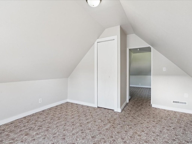 226 2nd Ave E, Lisbon, IA 52253 - additional living space with carpet floors and vaulted ceiling