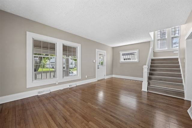 351 19th St SE, Cedar Rapids, IA 52403 - entrance foyer featuring wood finished floors, a textured ceiling, and stairs