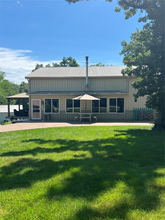 101 Canyon Rd, Montezuma, IA 50171 - back of house featuring a yard