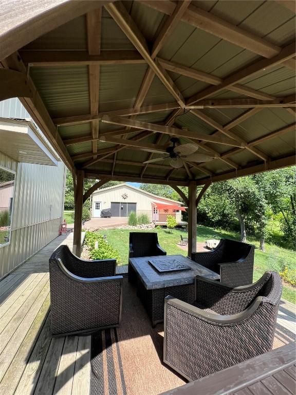 101 Canyon Rd, Montezuma, IA 50171 - deck featuring outdoor lounge area, a gazebo, and an outbuilding