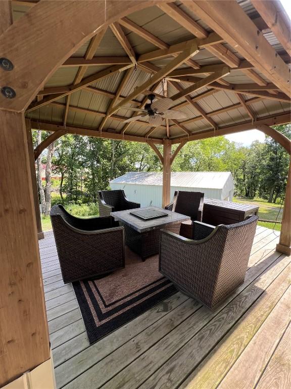 101 Canyon Rd, Montezuma, IA 50171 - deck with outdoor lounge area, a ceiling fan, and a gazebo