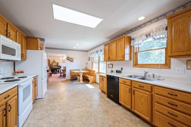 1827 Hamer Dr NW, Cedar Rapids, IA 52405 - kitchen with white appliances, light countertops, light floors, brown cabinetry, and recessed lighting