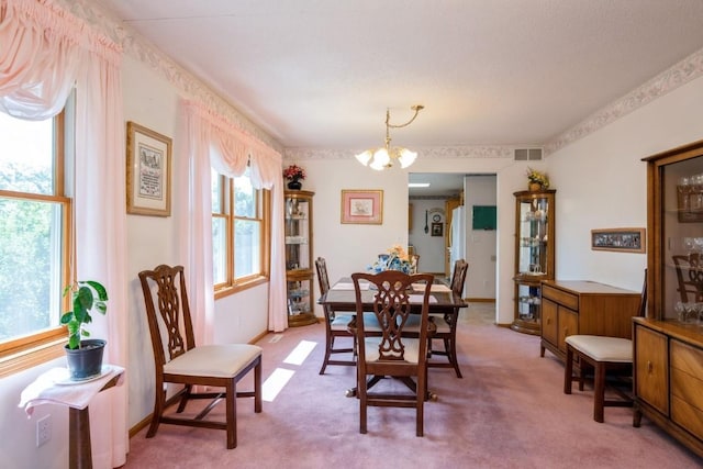 1827 Hamer Dr NW, Cedar Rapids, IA 52405 - dining area featuring a chandelier and carpet flooring