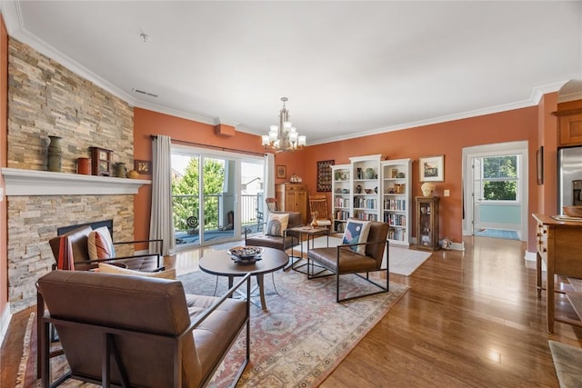1138 Swisher St, Iowa City, IA 52245 - living area with a chandelier, ornamental molding, healthy amount of natural light, wood finished floors, and a fireplace