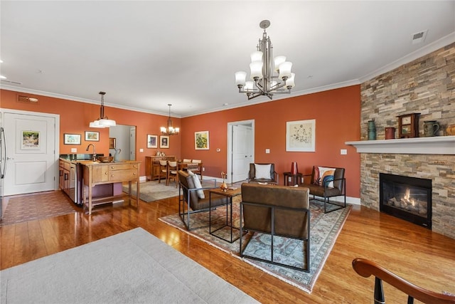 1138 Swisher St, Iowa City, IA 52245 - living area with a chandelier, wood-type flooring, crown molding, and a fireplace