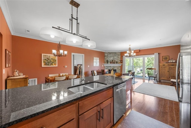 1138 Swisher St, Iowa City, IA 52245 - kitchen featuring a chandelier, stainless steel appliances, open floor plan, wood finished floors, and crown molding