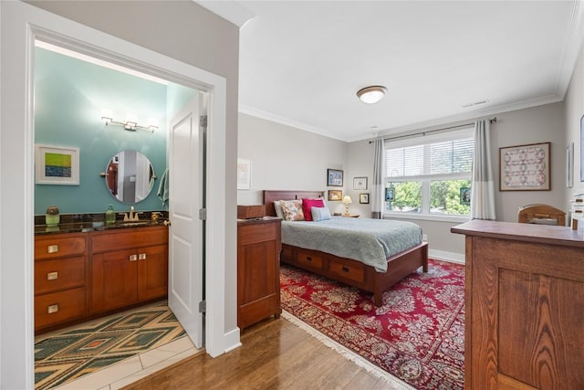 1138 Swisher St, Iowa City, IA 52245 - bedroom with ornamental molding and wood finished floors
