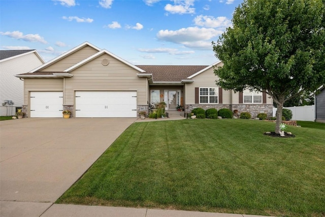 2012 Radcliffe Dr SW, Cedar Rapids, IA 52404 - view of front of property with an attached garage, concrete driveway, stone siding, and roof with shingles