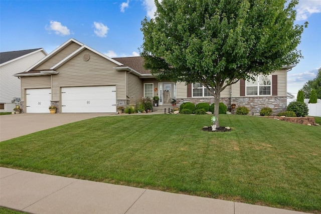 2012 Radcliffe Dr SW, Cedar Rapids, IA 52404 - view of front of house featuring an attached garage, stone siding, driveway, and a front yard
