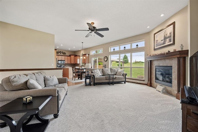 2012 Radcliffe Dr SW, Cedar Rapids, IA 52404 - living area featuring a ceiling fan, light carpet, a fireplace, and recessed lighting