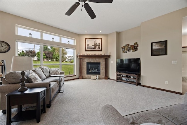2012 Radcliffe Dr SW, Cedar Rapids, IA 52404 - carpeted living area featuring a ceiling fan, a tiled fireplace, and recessed lighting