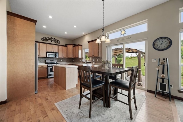 2012 Radcliffe Dr SW, Cedar Rapids, IA 52404 - dining area featuring light wood-style floors, recessed lighting, and a towering ceiling