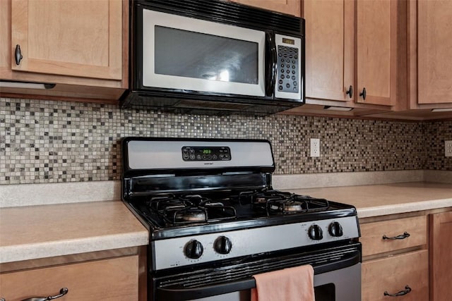 2012 Radcliffe Dr SW, Cedar Rapids, IA 52404 - kitchen with appliances with stainless steel finishes, light countertops, and tasteful backsplash
