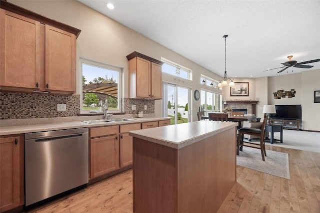 2012 Radcliffe Dr SW, Cedar Rapids, IA 52404 - kitchen featuring dishwasher, a warm lit fireplace, light wood-type flooring, healthy amount of natural light, and recessed lighting