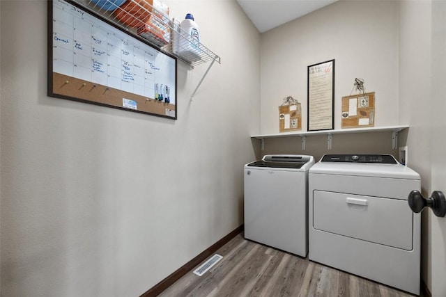 2012 Radcliffe Dr SW, Cedar Rapids, IA 52404 - washroom with washer and clothes dryer and wood finished floors