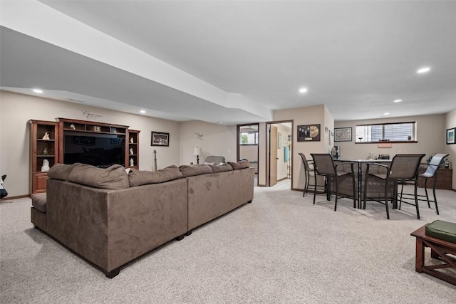 2012 Radcliffe Dr SW, Cedar Rapids, IA 52404 - carpeted living room with recessed lighting, healthy amount of natural light, and bar with sink