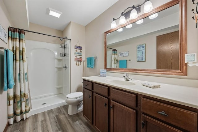 2012 Radcliffe Dr SW, Cedar Rapids, IA 52404 - bathroom with vanity, curtained shower, and wood finished floors